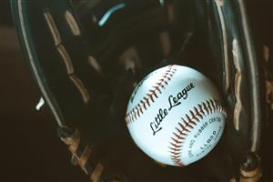 Little league baseball in glove