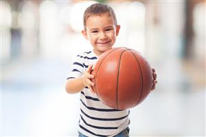 Smiling Toddler Boy Holding A Basketball